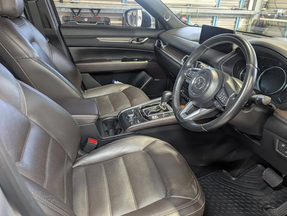 Clean leather front seats and centre console inside an SUV